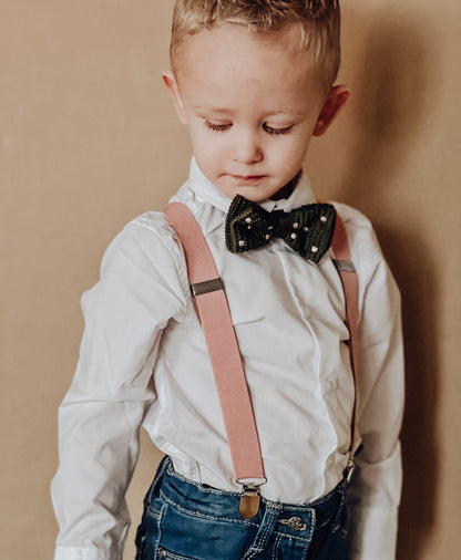 Pink suspenders with green bow tie
